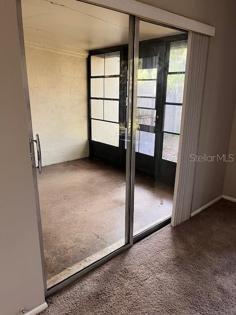 doorway to outside with carpet floors