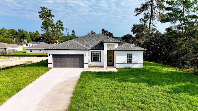 view of front of property with a front lawn and a garage