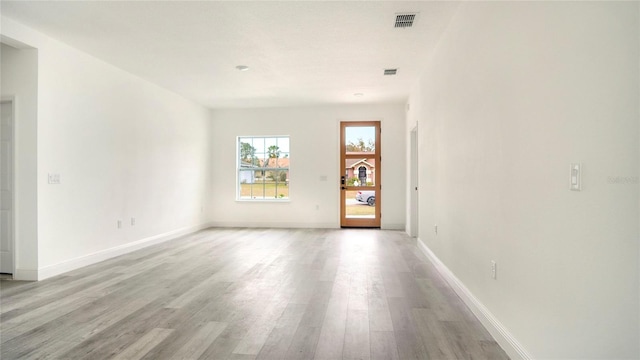 unfurnished room with light wood-type flooring