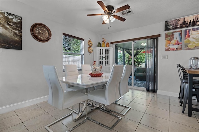 tiled dining area featuring ceiling fan