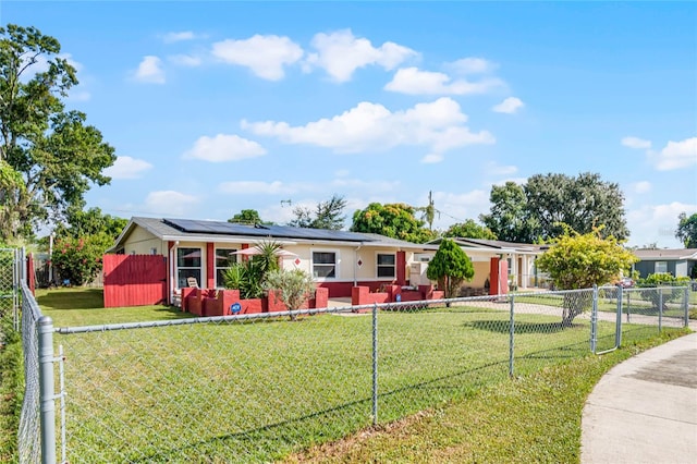 single story home with a front lawn and solar panels