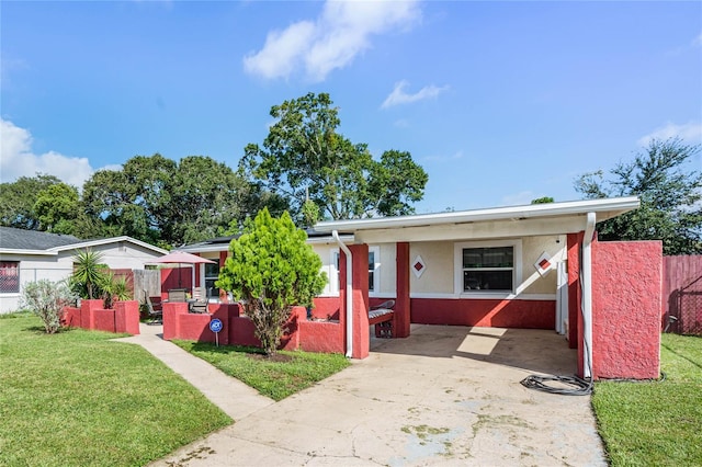 bungalow-style house with a carport and a front yard