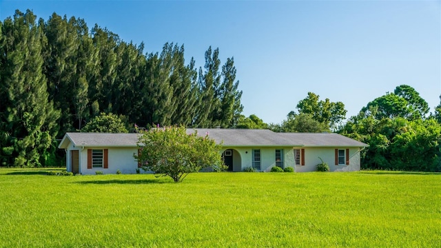 ranch-style house with a front lawn