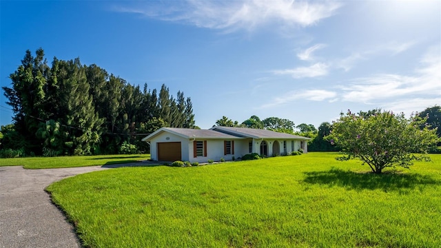 ranch-style house with a garage and a front yard