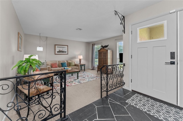 entryway featuring dark colored carpet