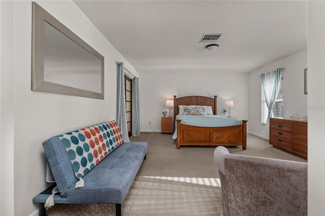 carpeted bedroom featuring a textured ceiling