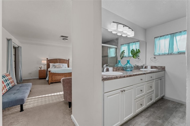 bathroom featuring a shower with door and vanity