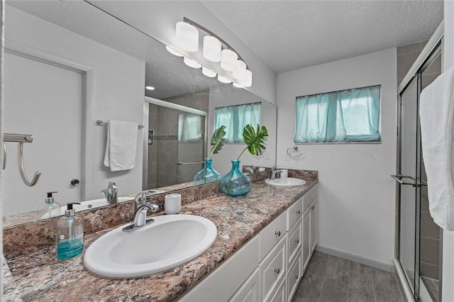 bathroom with walk in shower, vanity, and a wealth of natural light