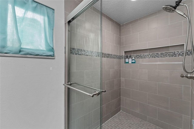 bathroom with a shower with door