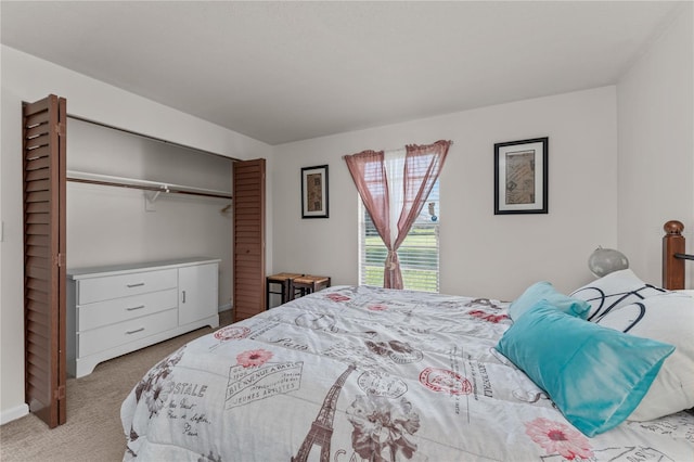 bedroom with light carpet and a closet