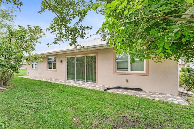 rear view of property with a lawn