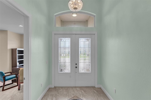 2416 SE 8th Ave, Cape Coral, FL 33990 - foyer entrance with baseboards, french doors, and a chandelier