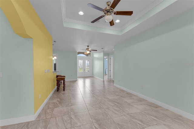 spare room with french doors, a raised ceiling, ceiling fan, and crown molding