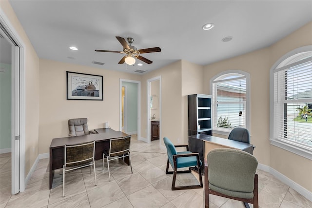 office area with a wealth of natural light and ceiling fan