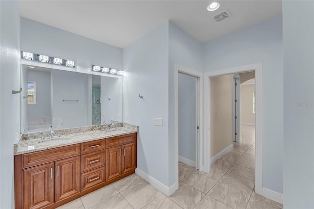 bathroom with vanity and a shower