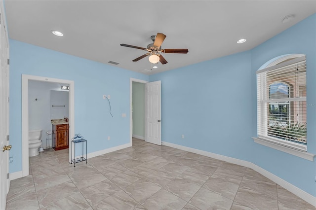 unfurnished bedroom featuring connected bathroom and ceiling fan