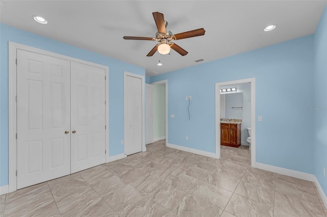 2416 SE 8th Ave, Cape Coral, FL 33990 - unfurnished bedroom with visible vents, baseboards, marble finish floor, multiple closets, and connected bathroom