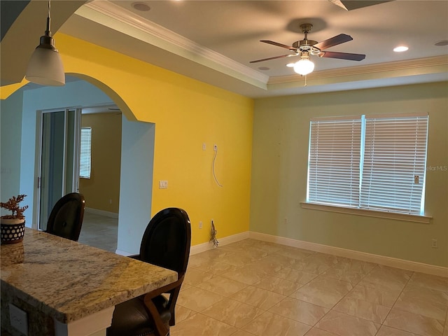 office space featuring ceiling fan, a raised ceiling, and ornamental molding