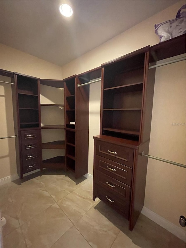 spacious closet featuring light tile patterned flooring