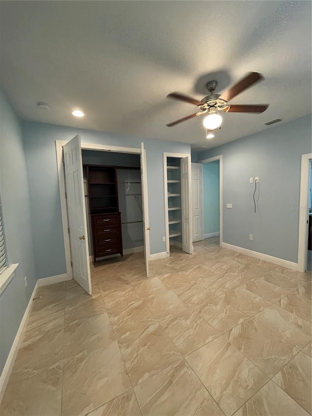 unfurnished bedroom with a textured ceiling and ceiling fan