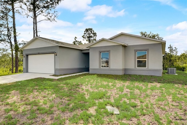 single story home with central AC unit, a front yard, and a garage