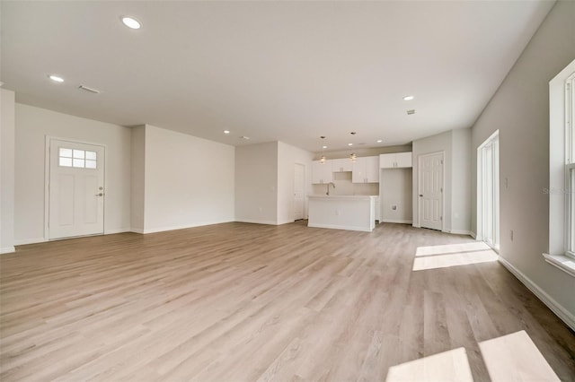 unfurnished living room with light wood-type flooring