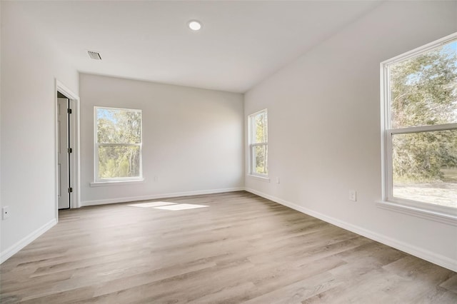 unfurnished room featuring light hardwood / wood-style flooring and a wealth of natural light