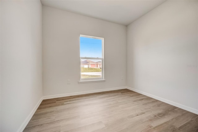 spare room featuring light hardwood / wood-style flooring