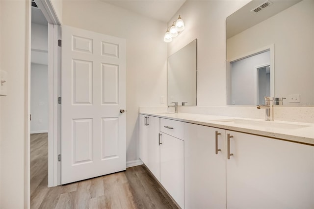 bathroom with vanity and hardwood / wood-style floors