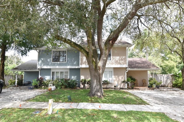 front of property featuring a front yard and a carport