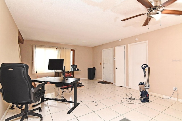 home office with ceiling fan, light tile patterned floors, and a textured ceiling