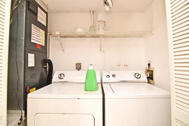 laundry area with a textured ceiling and independent washer and dryer