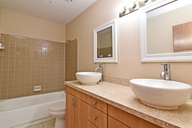 full bathroom with tile patterned floors, tiled shower / bath combo, vanity, and toilet