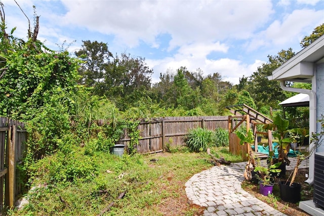 view of yard with central AC unit and a gazebo