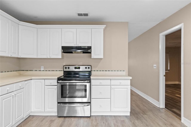 kitchen featuring white cabinetry, light hardwood / wood-style floors, and stainless steel electric range