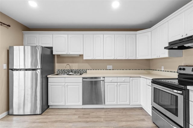 kitchen with white cabinets, light hardwood / wood-style floors, stainless steel appliances, and sink