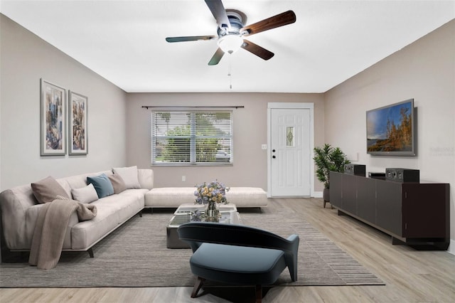 living room featuring light hardwood / wood-style flooring and ceiling fan