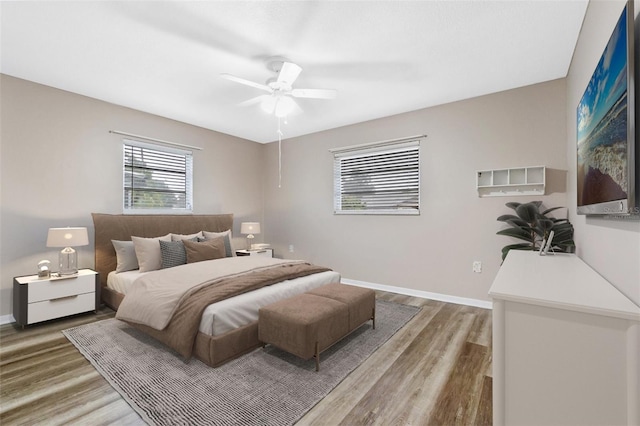 bedroom with ceiling fan and hardwood / wood-style floors