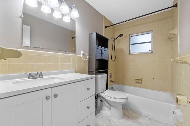 full bathroom with decorative backsplash, vanity, tile walls, tiled shower / bath combo, and toilet