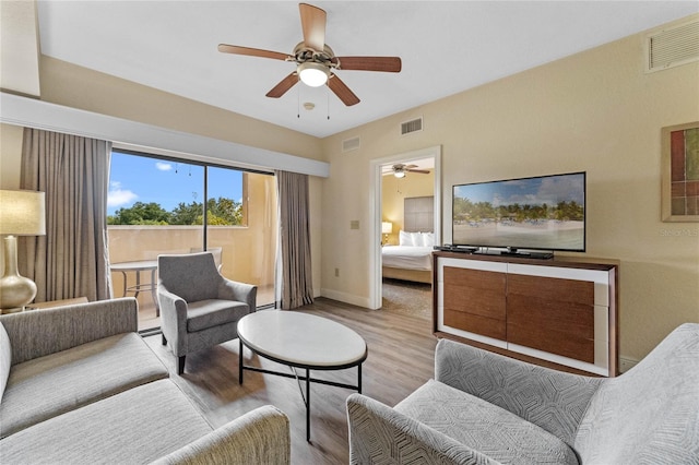 living room featuring light wood-type flooring and ceiling fan