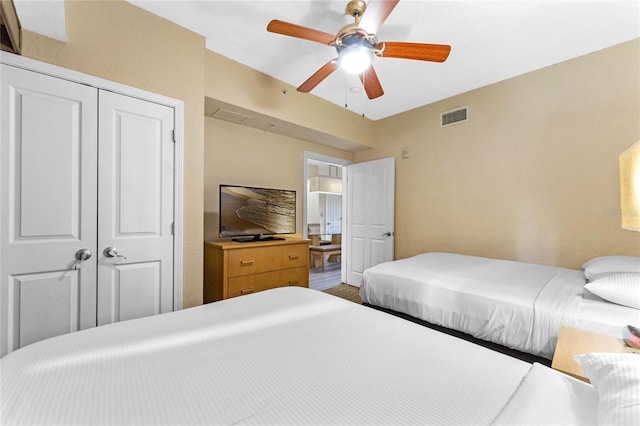 bedroom with ceiling fan and a closet