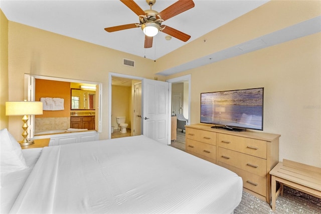 bedroom featuring ceiling fan and ensuite bath