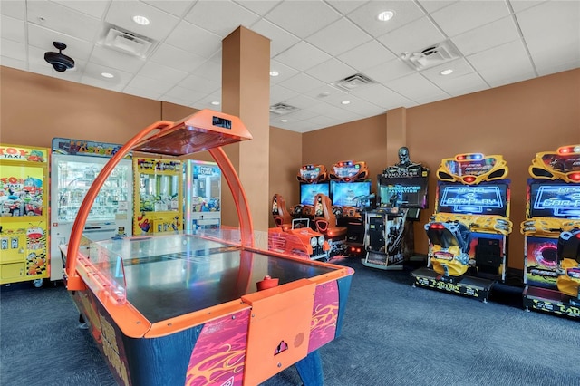 game room with a drop ceiling and dark colored carpet