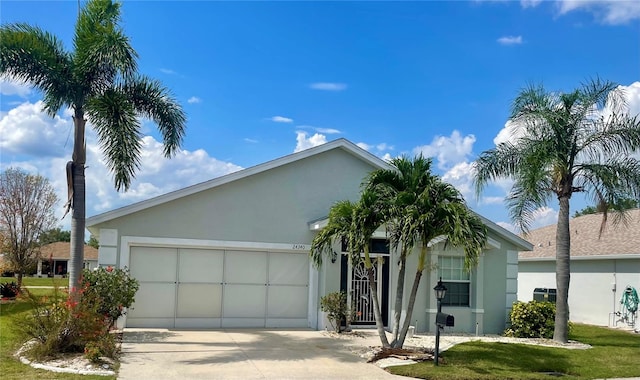 ranch-style home with a front yard, a garage, and cooling unit