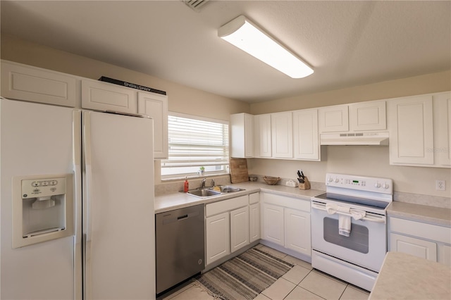 kitchen featuring white appliances, light tile patterned floors, sink, and white cabinets