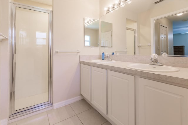 bathroom featuring vanity, tile patterned floors, and an enclosed shower