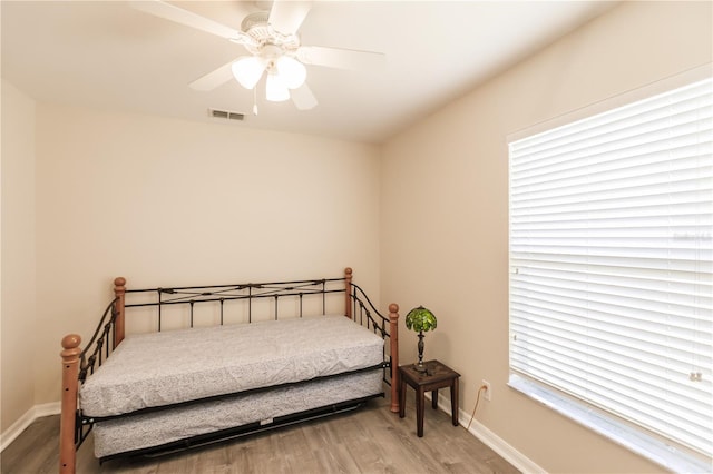 bedroom with hardwood / wood-style floors and ceiling fan