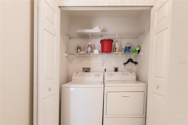 clothes washing area with washing machine and dryer