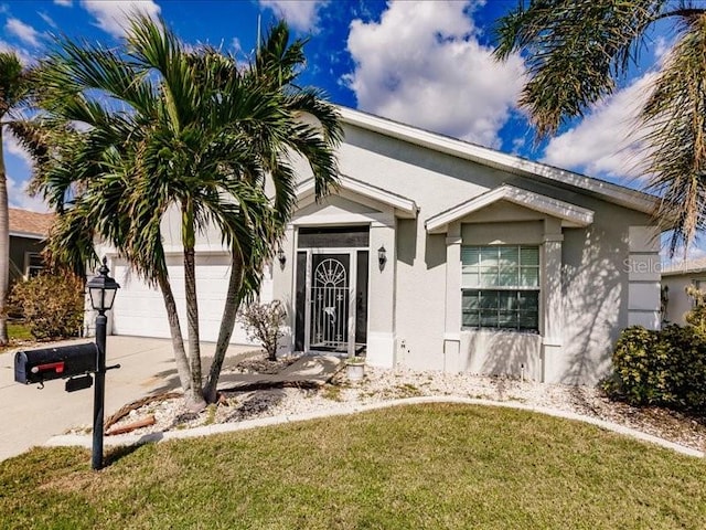 view of front of house with a front yard and a garage