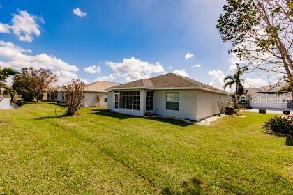 rear view of property featuring a yard